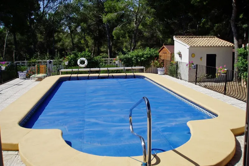 Piscina exterior de una vivienda con el agua limpia y la línea de flotación repasada